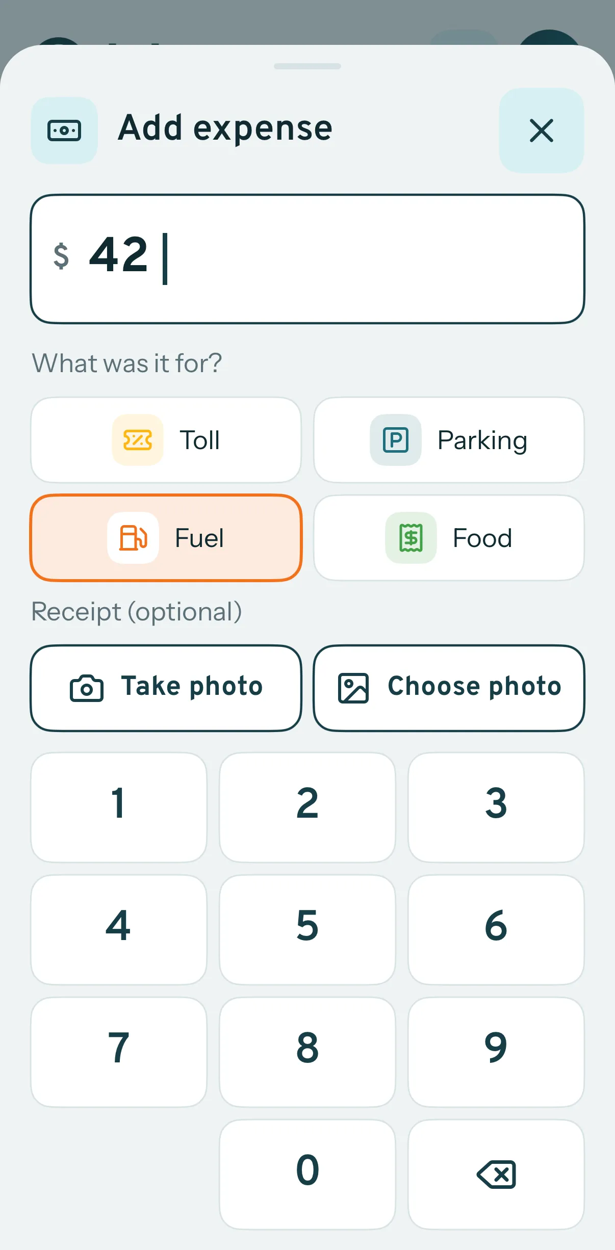 Logging a fuel expense of $42 against a trip in the driver app, with toll, parking and food as the other choices and buttons to take or choose a photo of the receipt.