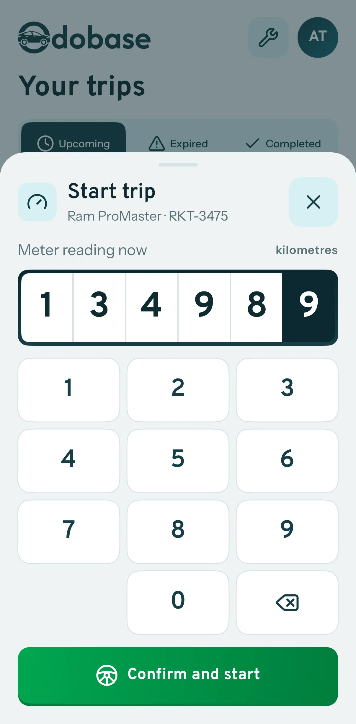 Starting a trip in the driver app: the driver confirms the van's odometer reading on a large keypad before the trip begins.