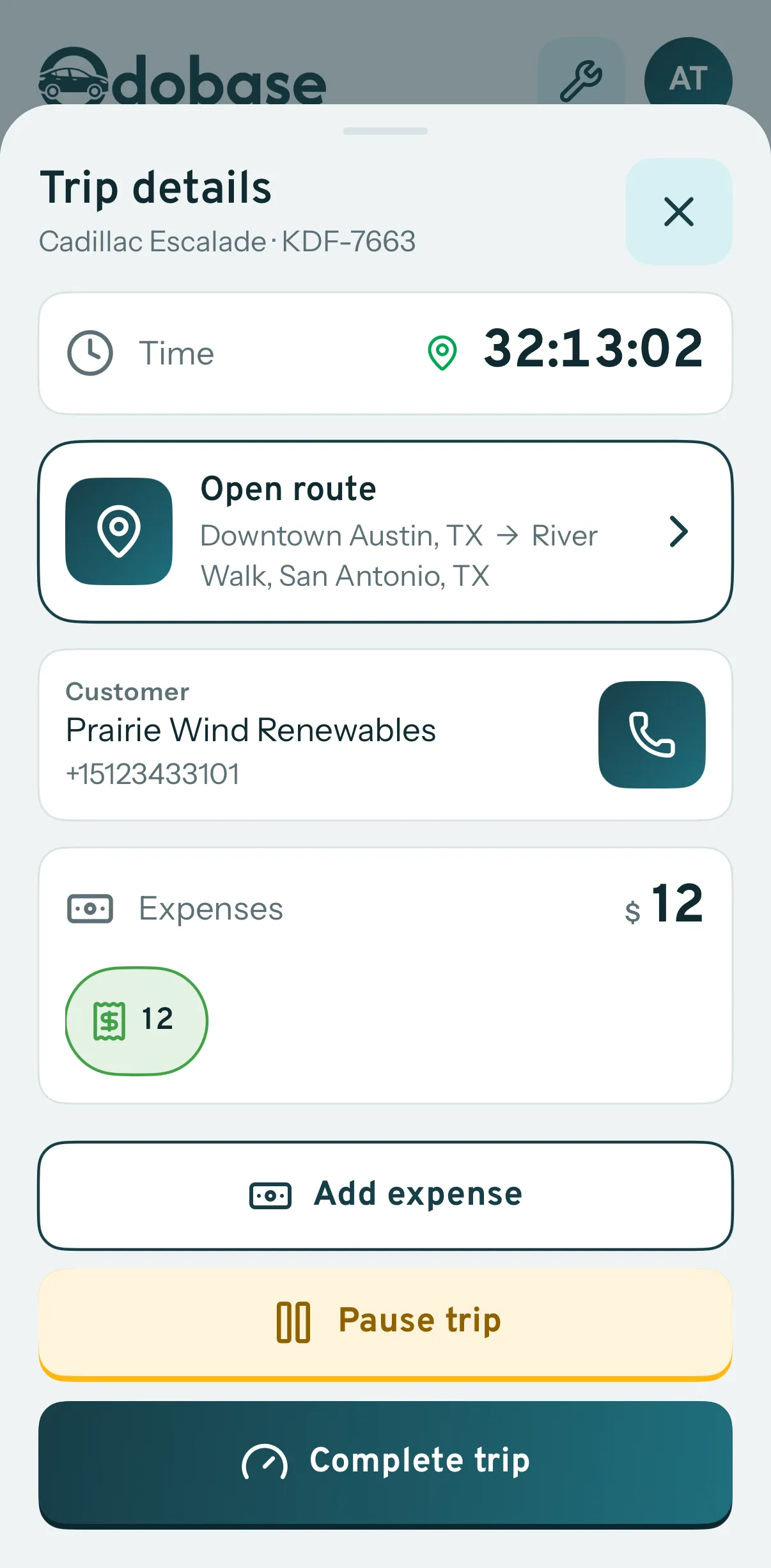 A running trip in the driver app: its time on the road, the route to open in maps, the customer to call, the expenses logged so far, and buttons to add an expense, pause or complete the trip.